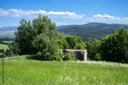 A drone view of a concrete blockhouse of the former czechoslovak fortification in Orlicke hory. In the background massif of Suchy vrch hills. Mladkov, Eastern Bohemia, Czechia photo