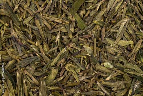 Close up Chinese green leaf tea. Dried tea leaves, top view. Macro