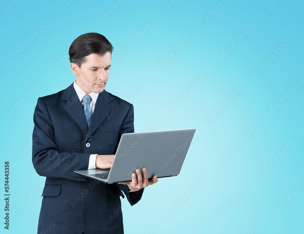 Happy young business man employee holding laptop Happy young business man employee holding laptop