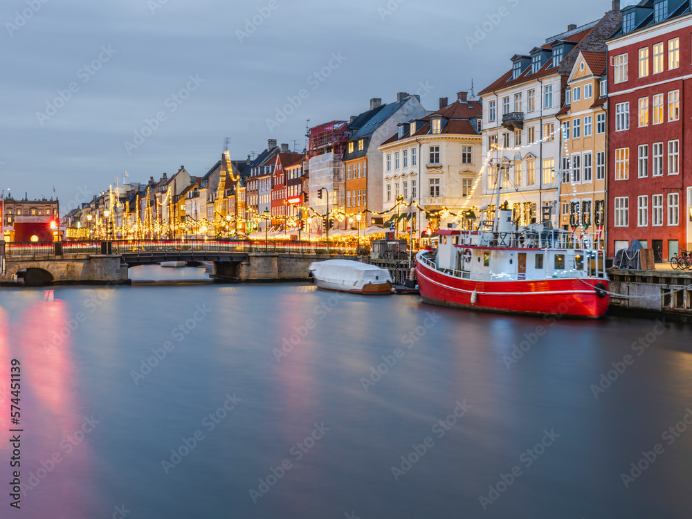 Colorful building of the old Nyhavn harbour lit up with Christmas lights, Copenhagen, Denmark