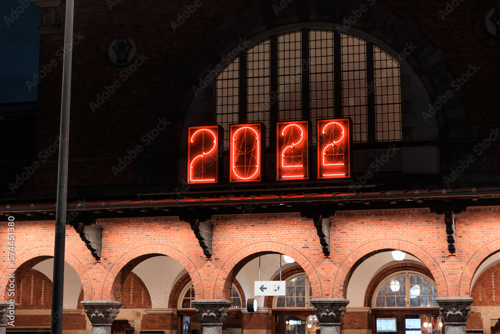 illuminated clock at night at main train station in Copenhagen, Denmark