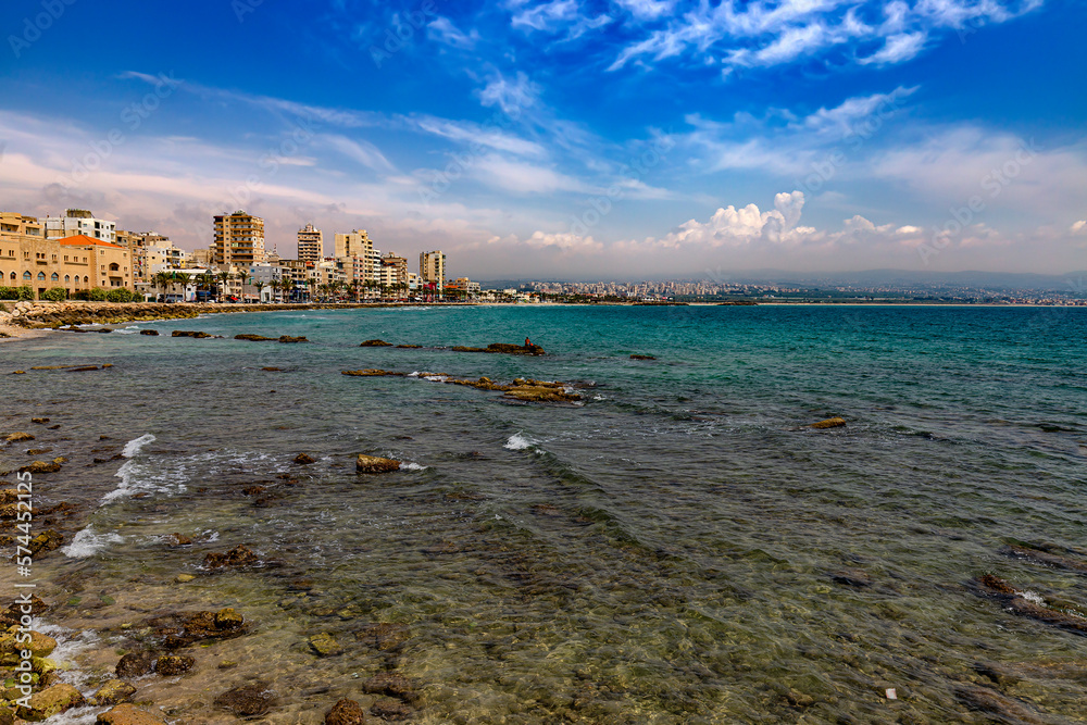Lebanon. Tyre (UNESCO World Heritage Site), Al Mina Archeological Site. Egyptian harbor - the remains of mole and sunken ancient columns. There is a modern city in the background
