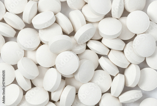 Heap of medicine white pills, antibiotic tablets, drugs. Pharmacy theme. Close-up, macro, top view © rynaonair