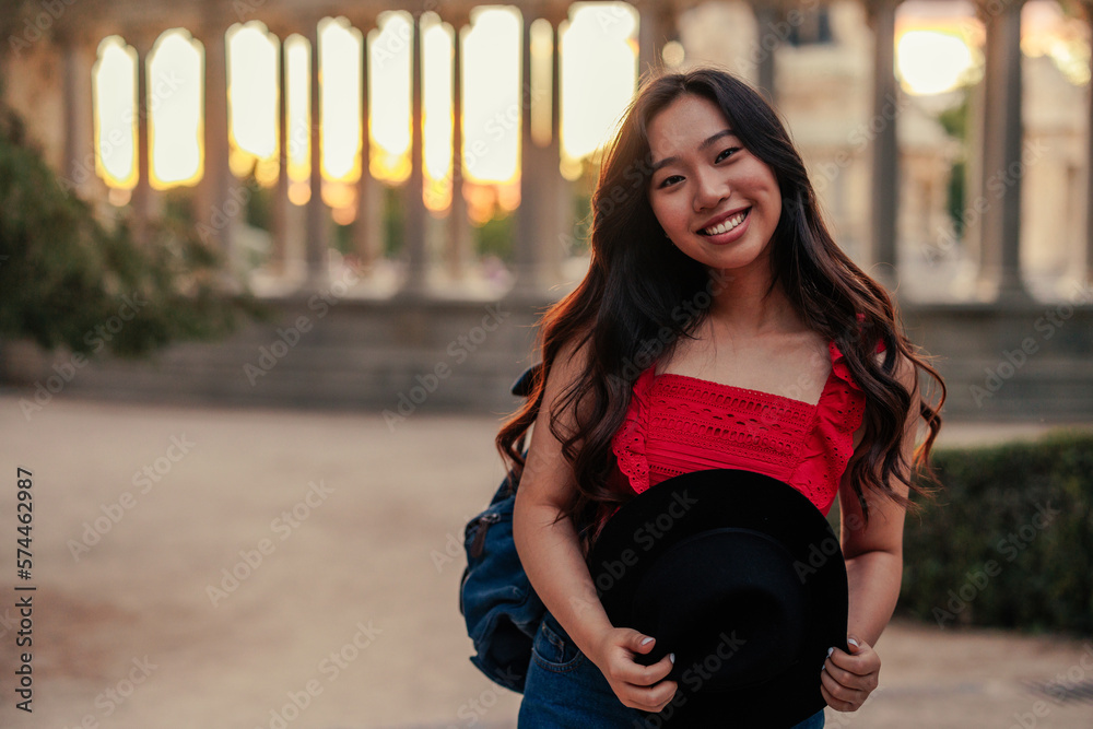 Portrait of beautiful Asian woman outdoors in city street smiling