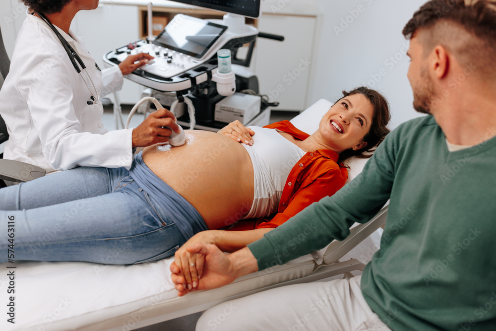 Young pregnant woman with husband on ultrasound. Young pregnant woman with husband on ultrasound.
