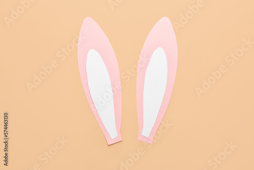 Paper bunny ears on beige background