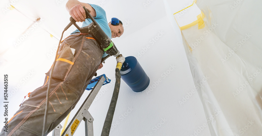 male worker preparing a chimney installation for a modern, energy saving heating stove.
