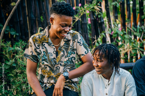 Queer masculine black women talking in a garden