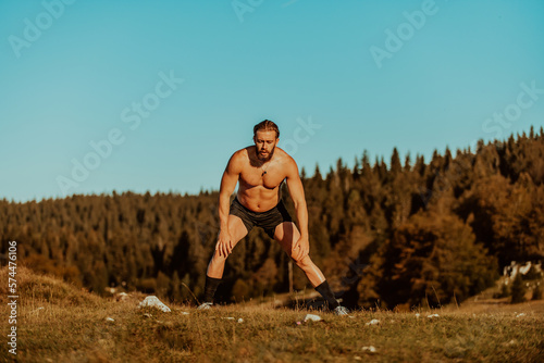 A man stretching after a hard workout in the early hours of the morning