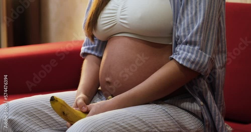 Closeup of pregnant woman belly during laughing