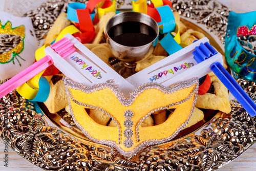 Purim festival is Jewish holiday that is celebrated with cookies, shofars, tallits, carnival masks, and hamantaschens photo