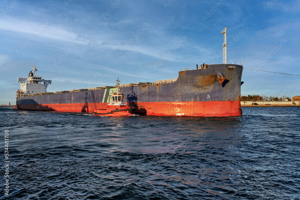Port of Gdansk, Baltic Sea, A large bulk carrier with a displacement of 81,703 t DWT, built in 2019, enters the port with the assistance of tugboats, the ship is 228.99 meters long, 32 meters wide, an