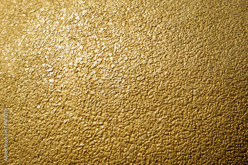 Gold concrete wall texture or background and copy space.