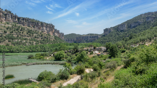 The lagoon of Uña and its mountains is located in the town of Uña, in the province of Cuenca (Castilla La Mancha, Spain). In the photo we can see mountains and also many green trees. Spain