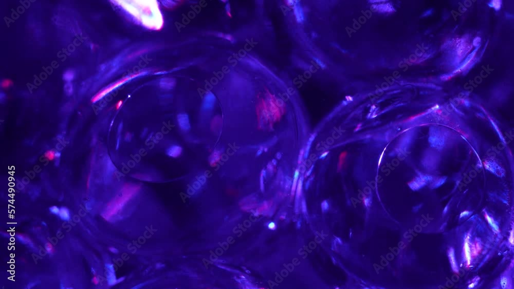Water color gel balls. Super macro bubbles slow motion. Bubbles of water. Liquid cream gel transparent cosmetic texture sample with bubbles. Background with hydrogel balls with glitter. Water color gel balls. Super macro bubbles slow motion. Bubbles of water. Liquid cream gel transparent cosmetic texture sample with bubbles. Background with hydrogel balls with glitter.