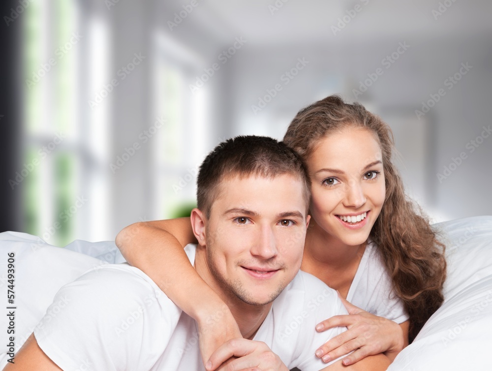 Happy morning woman and man in bed. Bedroom interior Happy morning woman and man in bed. Bedroom interior