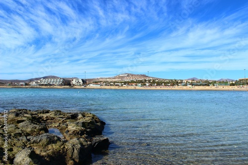 The lagoon of the touristic marina of Caleta de Fuste in the Canary Islands. Photo of the Barcelo beach and the promenade along the coastline. photo