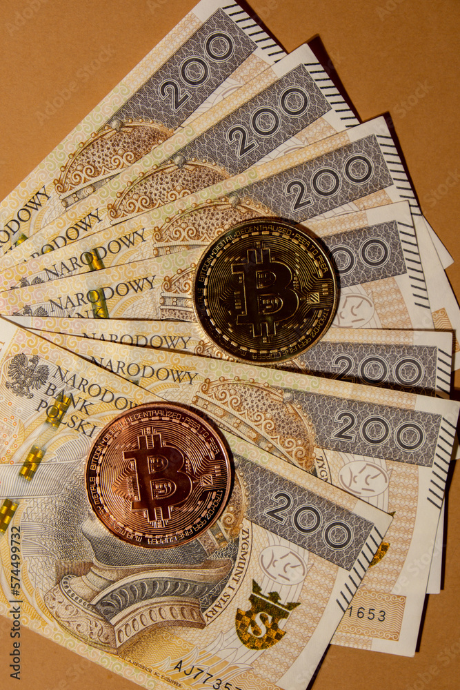 Bitcoin gold coin on bills of 200 polish zloty currency. Bitcoin mining trading concept. BTC golden money spinning around. Worldwide virtual internet Cryptocurrency or crypto digital payment system