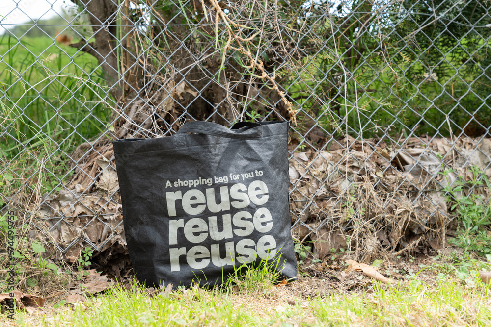 Black fabric bag for zero waste, environmentally friendly concept left as trash in city street