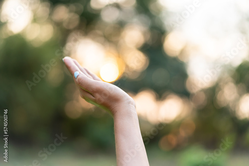 Woman hands on sunset background. © Bluesky60