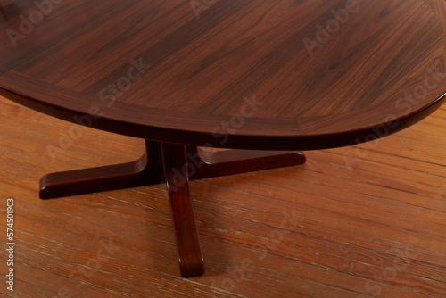 Elegant Rosewood Dining Table. Dark wooden table. View from above with hardwood floor.  photo