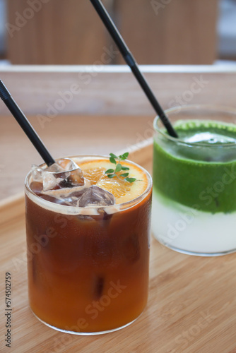 Iced americano with orange and iced matcha green tea in coffee shop