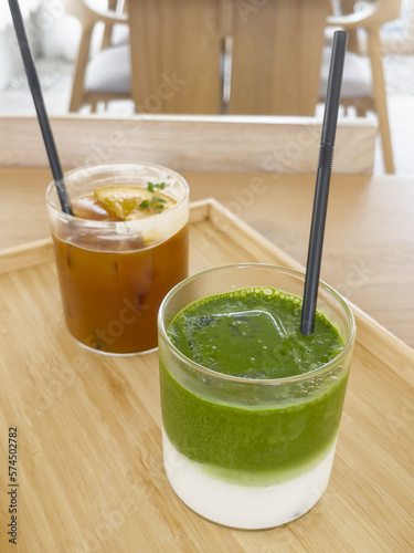 Iced americano with orange and iced matcha green tea in coffee shop