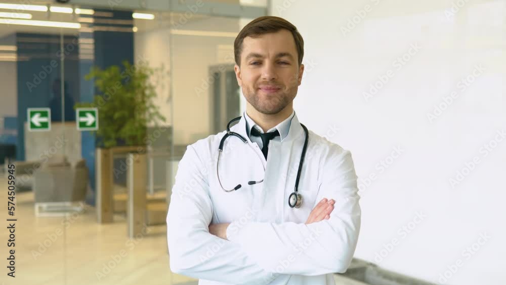 Smiling young Caucasian male doctor in white medical uniform show good quality service in hospital. Headshot portrait of happy man GP or pediatrician in clinic. Healthcare concept Smiling young Caucasian male doctor in white medical uniform show good quality service in hospital. Headshot portrait of happy man GP or pediatrician in clinic. Healthcare concept