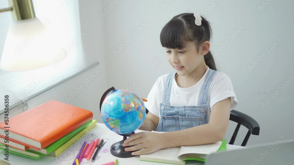 Portrait of happy young smiling child kid girl, Asian Thai woman searching at earth globe map model for travelling, people lifestyle. Portrait of happy young smiling child kid girl, Asian Thai woman searching at earth globe map model for travelling, people lifestyle.