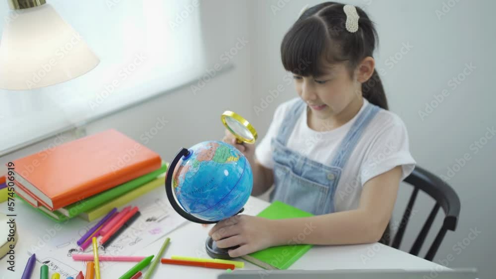 Portrait of happy young smiling child kid girl, Asian Thai woman searching at earth globe map model for travelling, people lifestyle. Portrait of happy young smiling child kid girl, Asian Thai woman searching at earth globe map model for travelling, people lifestyle.