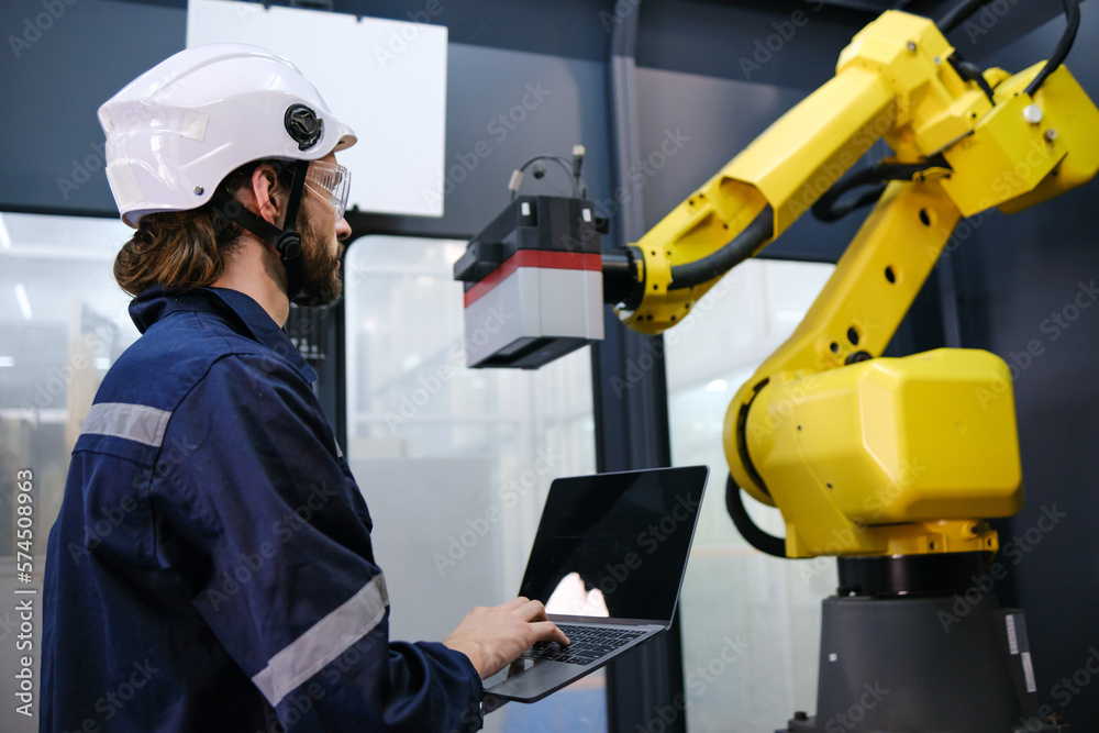 Engineer working in robotics factory Engineer working in robotics factory