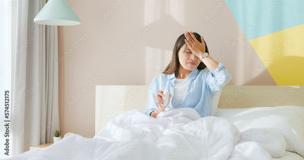 woman has headache on bed