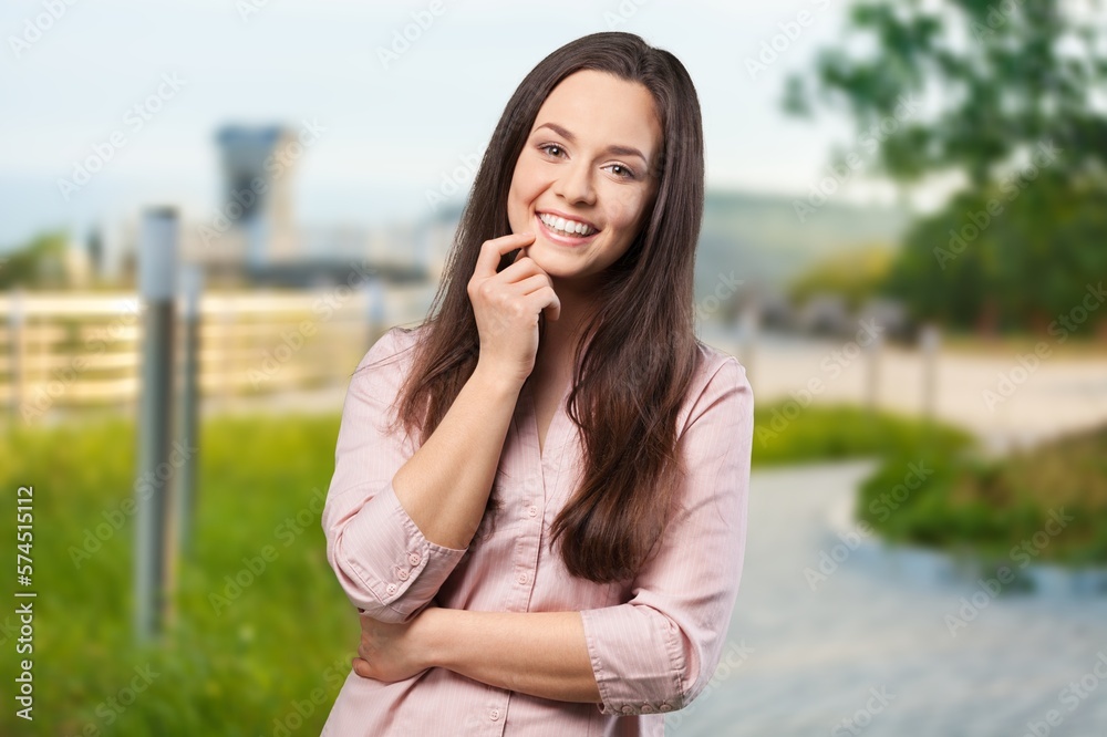 Happy young happy woman posing on outdoor background Happy young happy woman posing on outdoor background