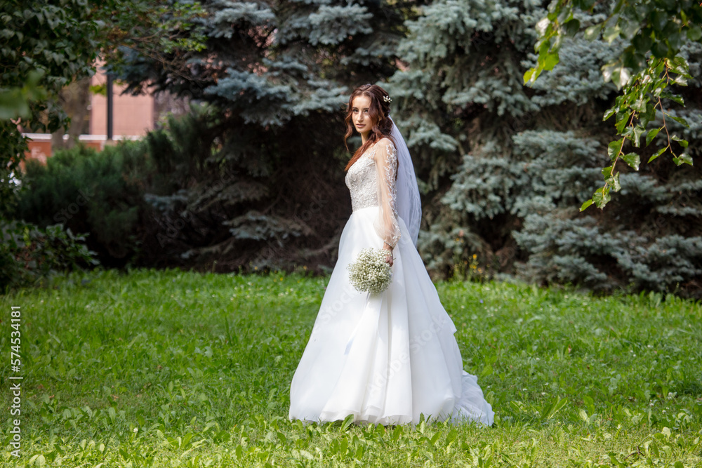 Girl in a wedding dress in nature.