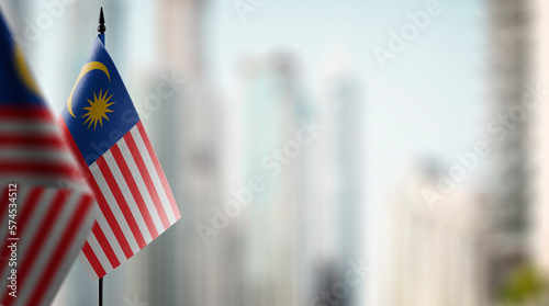 Canvas Print Small flags of the Malaysia on an abstract blurry background