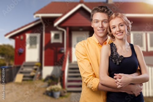 Happy young couple near house, lifestyle concept.