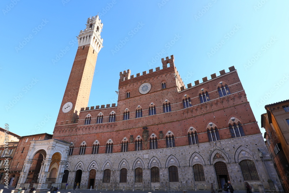 tower called TORRE DEL MANGIA and the town hall of Siena in the main square of the city in Italy