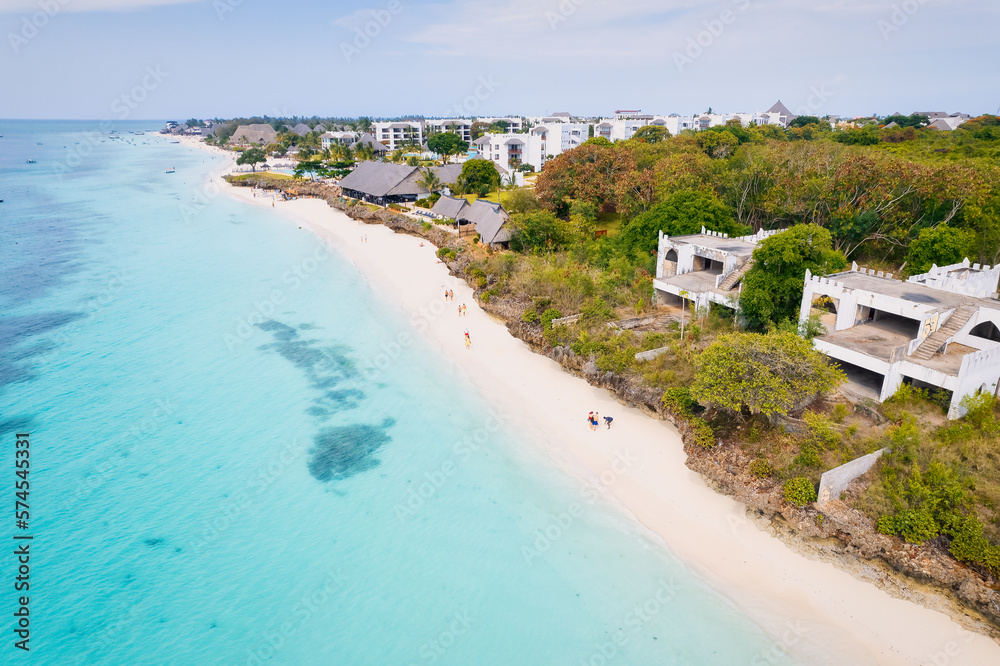 This drone shot of Nungwi Beach in Zanzibar captures the incredible beauty of the shoreline, with crystal-clear waters and golden sand providing a picture-perfect view. This drone shot of Nungwi Beach in Zanzibar captures the incredible beauty of the shoreline, with crystal-clear waters and golden sand providing a picture-perfect view.