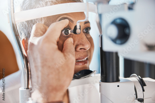 Senior eye zoom, retina check and medical eyes test of elderly woman at doctor consultation. Vision, healthcare focus and old female patient with consulting wellness expert for lens and glaucoma exam photo