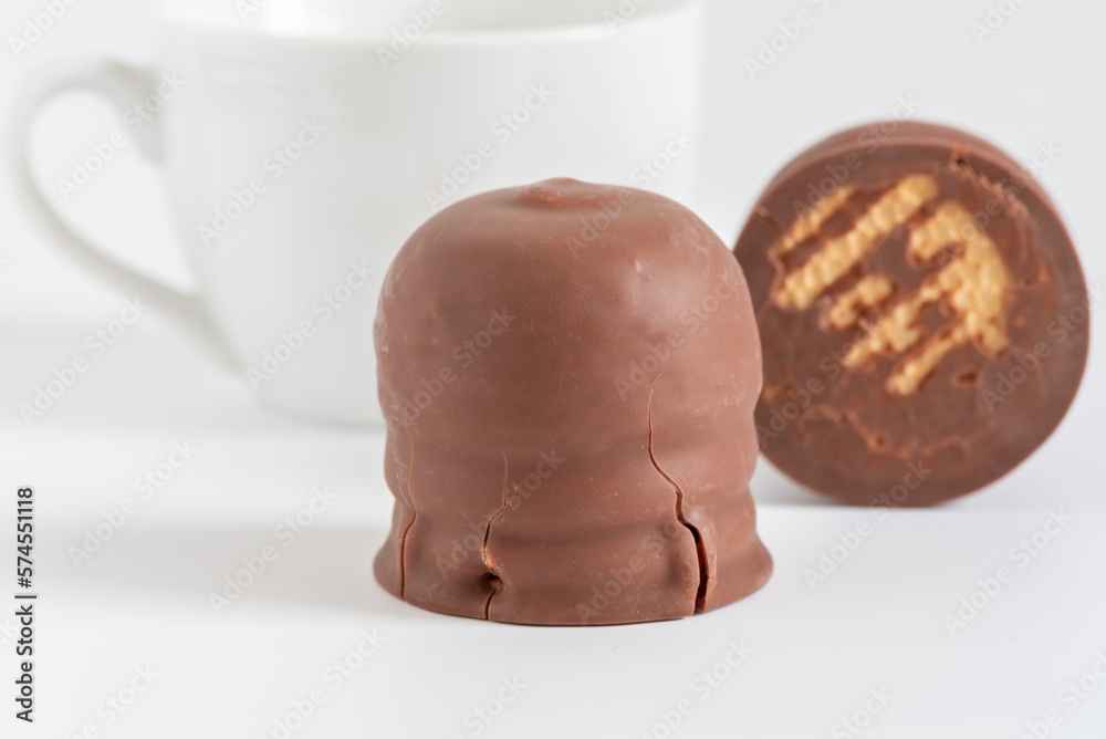Israeli winter dessert Krembo (chocolate covered marshmallow and cookie) on white background.
