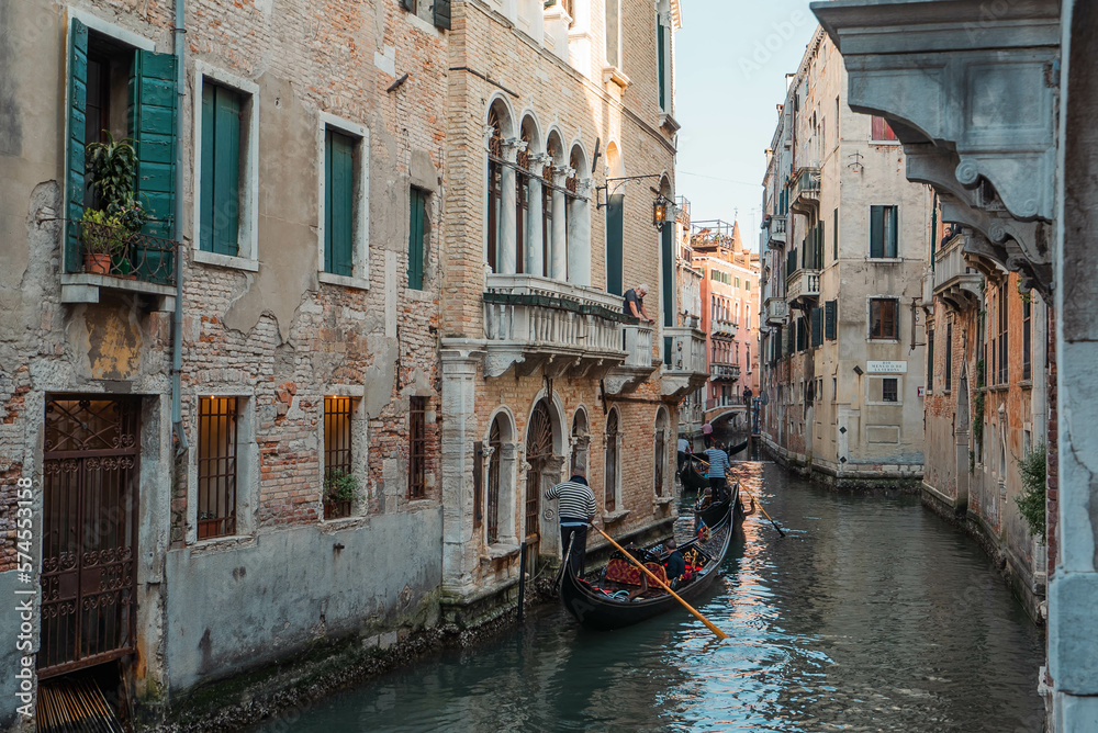 Venice Canal is lined on either side by Romanesque, Gothic, and Renaissance buildings with gondolas, the most famous traditional Venetian boat in Venice, Italy, house,