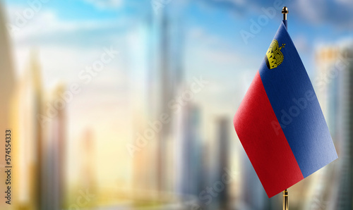 Tableau sur toile Small flags of the Liechtenstein on an abstract blurry background