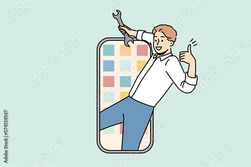 Smiling man with wrench in hands repair smartphone. Happy mechanic or technician fix cellphone application. Technology concept. Vector illustration. 