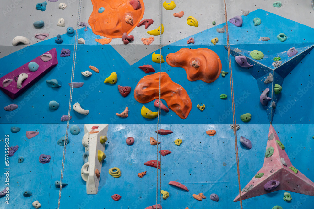 Multicolored bright high walls of the climbing wall / Interior of a