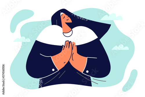 Woman nun of Christian church folded hands in front of chest to turn to God for help and pray 