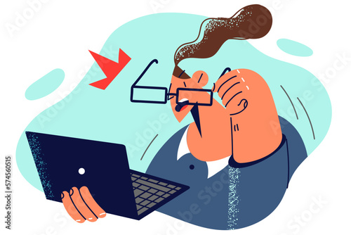 Stunned woman with laptop takes off glasses after seeing unexpected e-mail from business partners
