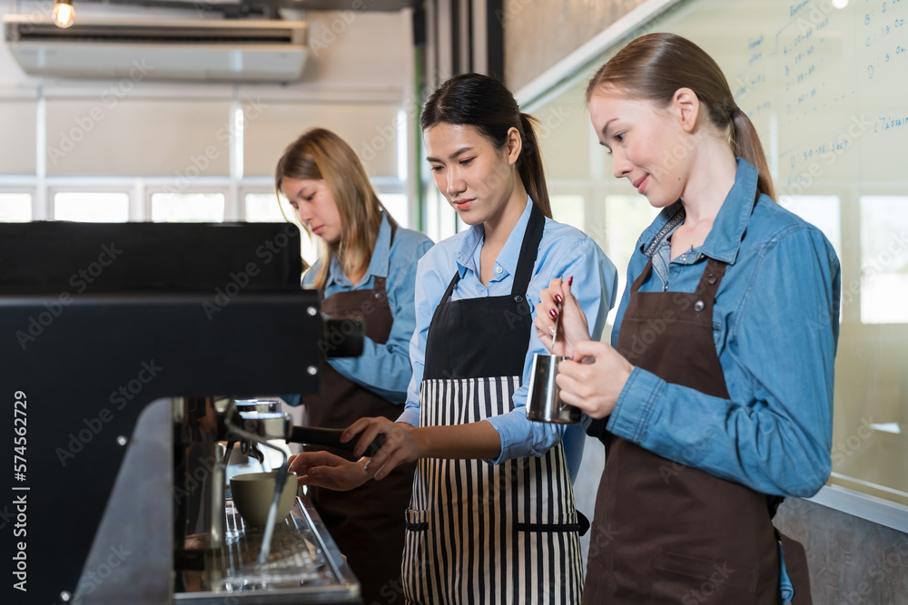 Group of young barista woman preparing coffee for customer in the cafe shop. Group of female waitress making coffee on steam espresso coffee machine at cafe shop