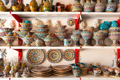 Tahran, Iran - 17th june, 2022 : special decorative iranian plates in on shelves in local shop in street bazaar market in city center