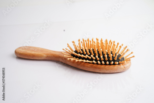 Hair loss fall with comb brush isolated on white background.
