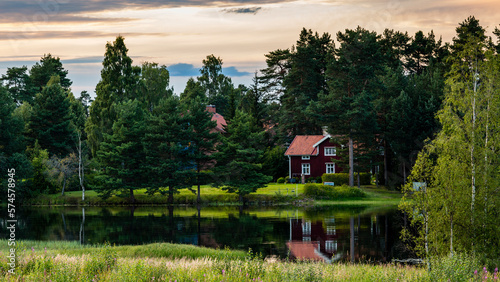 Typical Swedish house surrounded by trees, Mora, Dalarna, Sweden photo